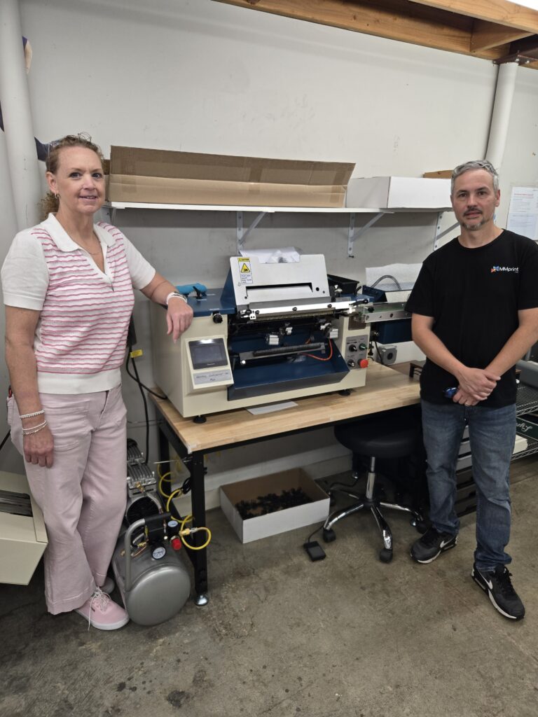 Carin Walter and Gio Jaramillo of The Marsid M & M Group with their Sterling® Coilmaster Jr. Plus automatic coil inserter