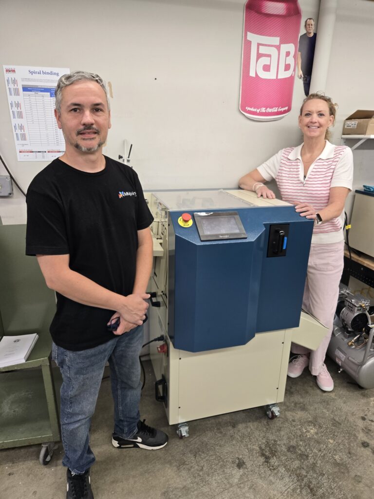 Carin Walter and Gio Jaramillo of The Marsid M & M Group with their Sterling® Digipunch automatic paper punch
